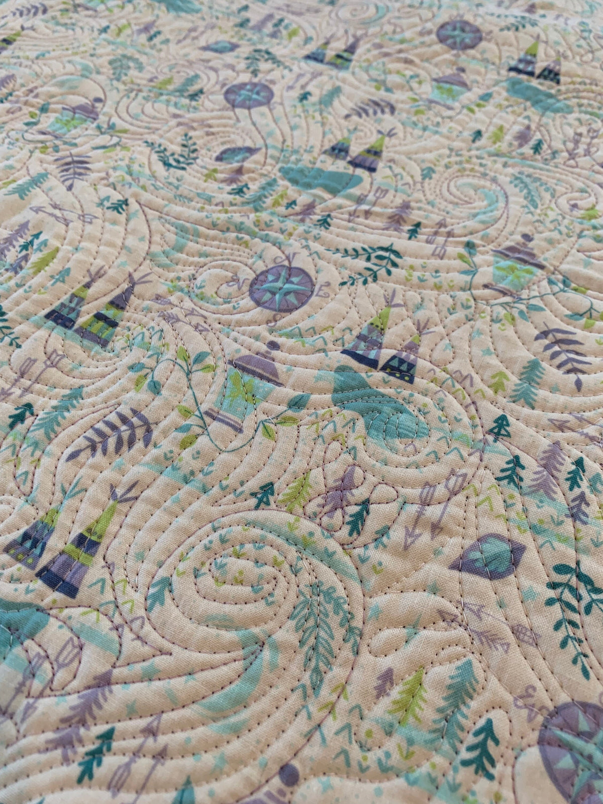Close-up of edge-to-edge quilting texture on Bohemian Neverland adventure cotton baby quilt