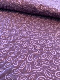 Close-up of purple paisley cotton fabric on baby quilt backing