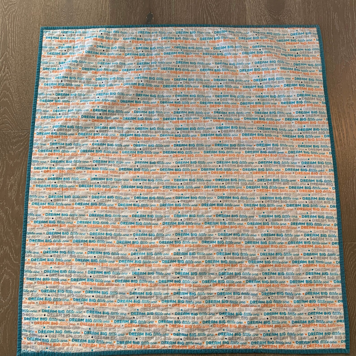 Dream Big little one print backing on handmade cotton baby quilt
